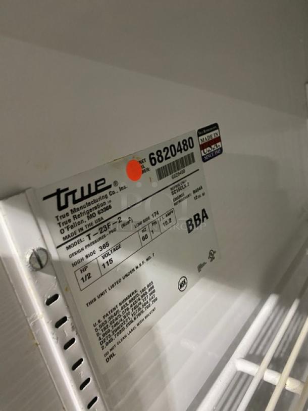 True T-23F-2 stainless steel reach-in freezer, SN 6820480, with poly coated rack, 115V, 1 phase, on casters. Labels shown.