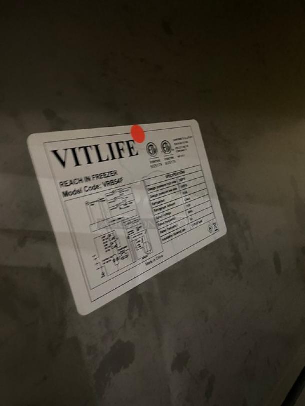 Vitlife VRB54F commercial stainless steel 2-door reach-in freezer with chrome-plated rack, model tag shown.