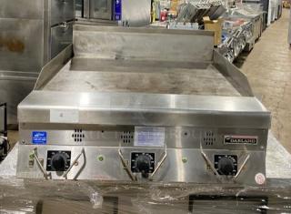 Garland commercial stainless steel gas griddle with back and side splash, thermostatic control, excellent condition.