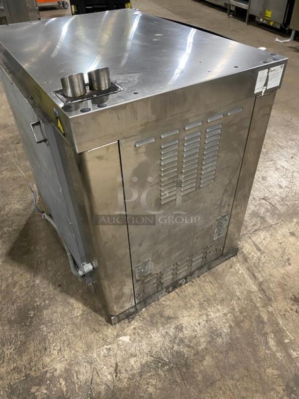 Alto-Shaam commercial stainless steel electric rotisserie oven with digital controls, visible wear, vent details.