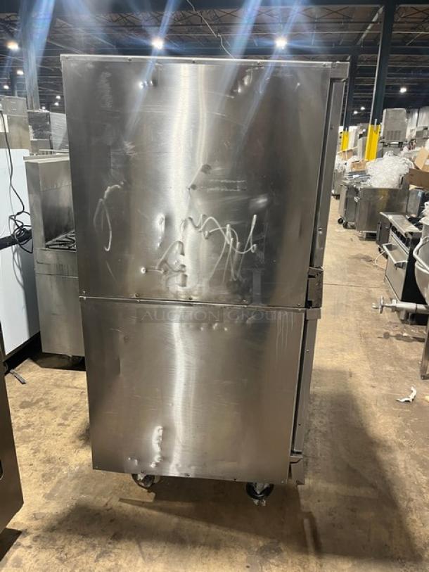 Imperial commercial stainless steel double stacked convection oven, natural gas powered, on casters, visible dents.