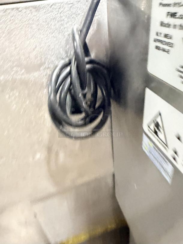 FWE 2019 Model HLC-1826-3-CHP stainless steel heated holding cabinet with coiled power cord, label showing specs, 120V.