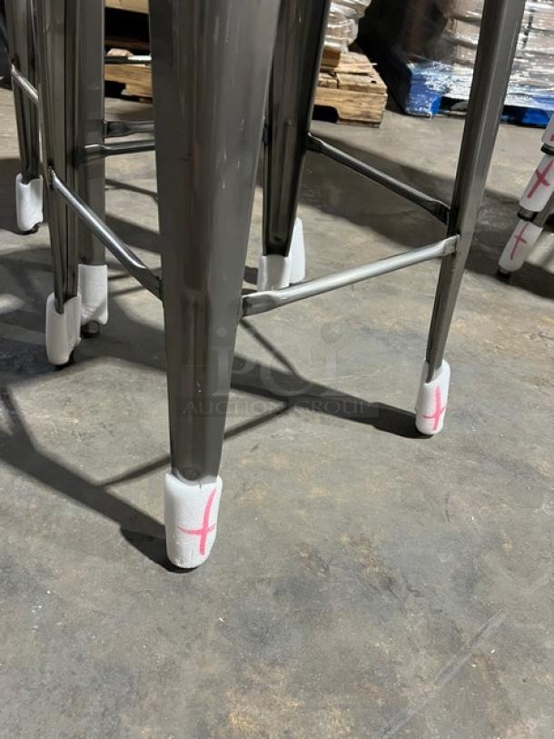 Brand new commercial gray gunmetal backless bar-height stool, stackable, industrial style, protective foot covers.