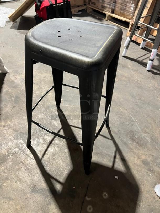 Black/Antique Gold distressed backless bar-height stool with stackable design. New condition, industrial style.