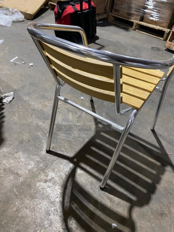 Brand new commercial aluminum stackable chair with faux teak slat back and seat, ideal for indoor/outdoor use.