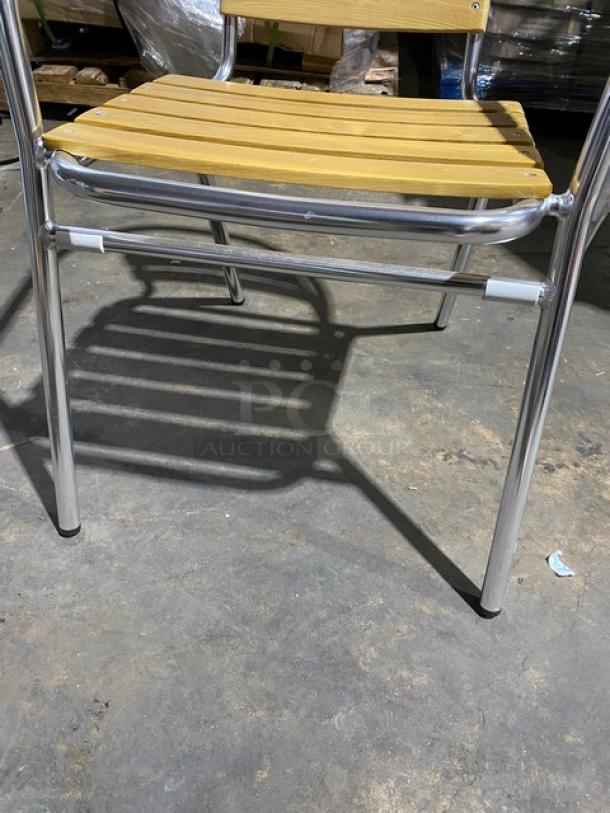 Brand new aluminum stackable dining chair with faux teak slats, ideal for indoor/outdoor use.