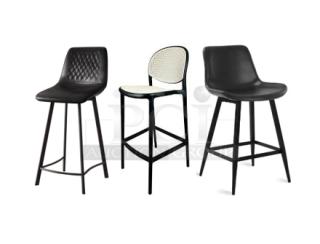 Three brand new modern bar-height dining chairs with black frames. Varied designs and cushioned seats.
