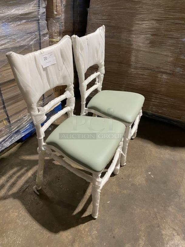 Brand new commercial white resin Chiavari dining chairs with sage green cushions, wrapped in protective plastic, set of two.