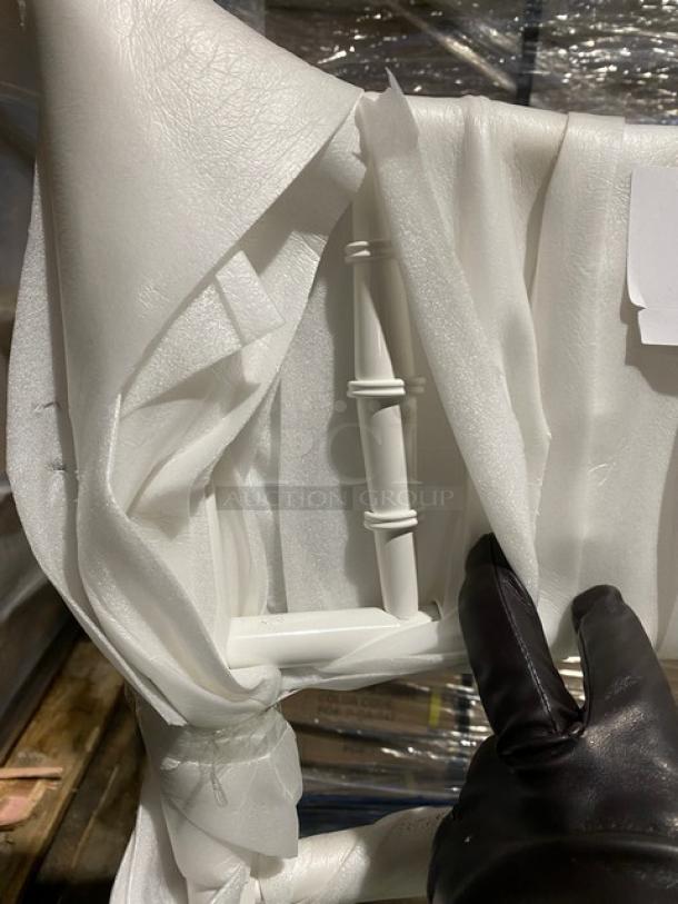 Brand new commercial white resin Chiavari dining chair with sage green cushion, wrapped in protective material.