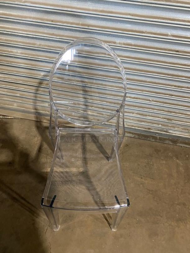 Transparent ghost-style stackable chair, brand new condition, suitable for indoor/outdoor use.