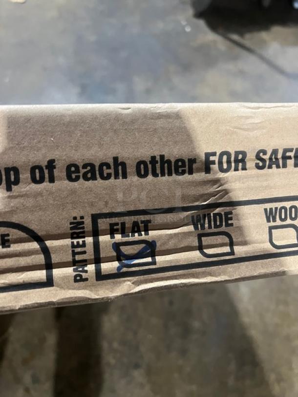 Brown cardboard packaging of a Rainbow Arizona outdoor table. Marked "FLAT" pattern and labeled for safety.