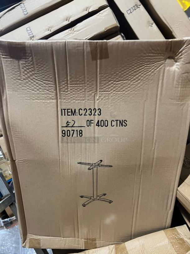 Cardboard packaging of a new DuroWood DW3636 dining table with barn wood plank design. Features a 36"x36" surface and 4-way pedestal base. Box marked "ITEM:C2323", image of base included.