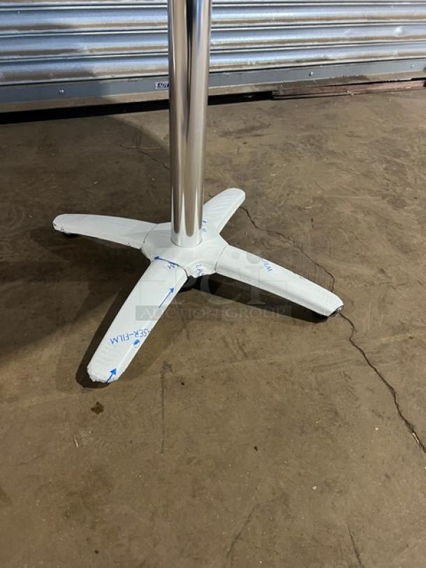 Barn Wood Plank Rustic DuroWood Round Dining Table with 4-way pedestal base, brand new, protective film visible on legs.