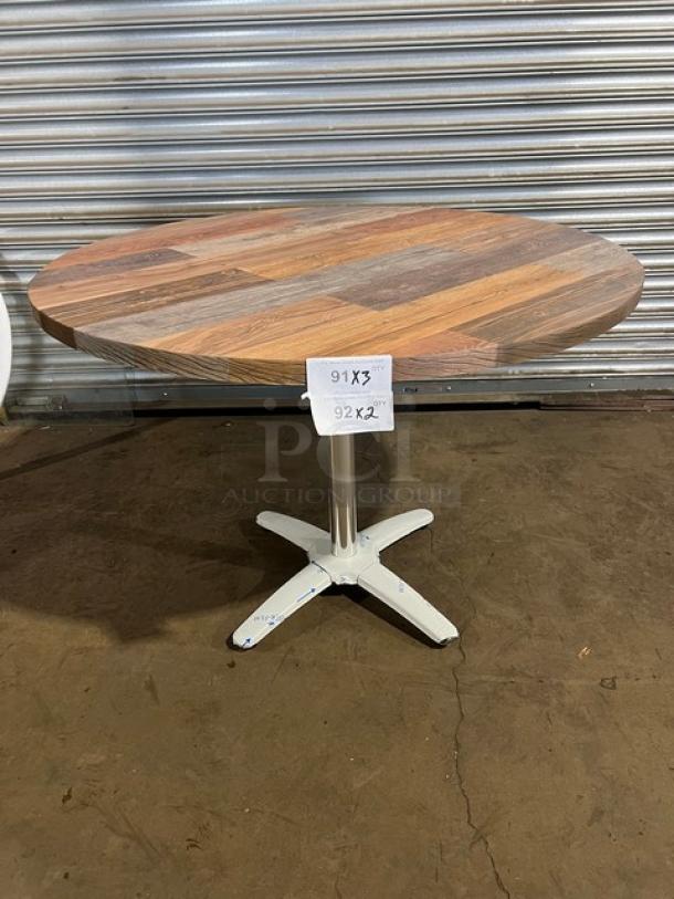 Brand new Barn Wood Plank Dining Table with round top, durable rustic design, and 4-way pedestal base. Measurements shown.