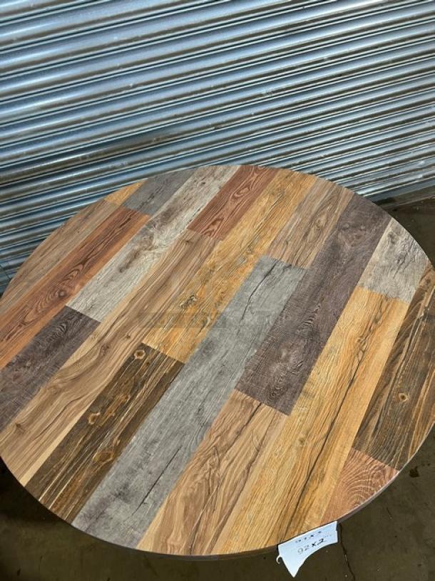 Brand new barn wood plank dining table with a round top and 4-way pedestal base. Rustic DuroWood, commercial grade.