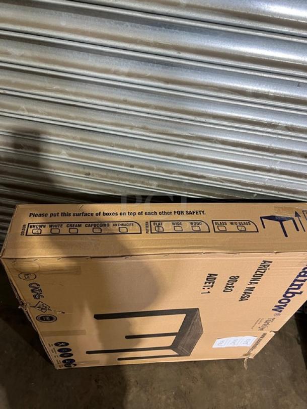 Brand new Rainbow Arizona 80"x80" square outdoor table in brown polypropylene faux wood, rattan finish, packaged in box.