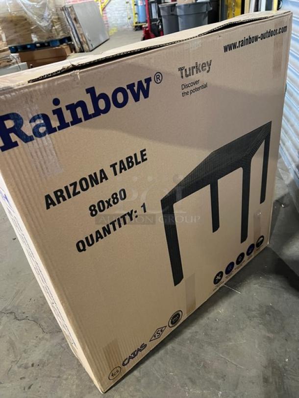 Brand new Rainbow Arizona 80"x80" outdoor table in box. Brown faux wood, polypropylene, rattan texture.