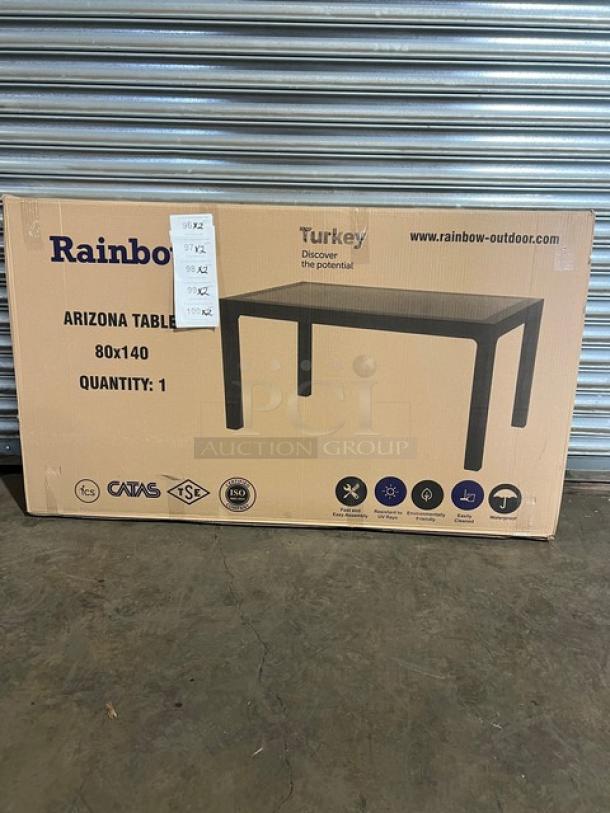 Brand new Rainbow Arizona Collection 140"x80" outdoor dining table in box. Features brown faux wood polypropylene with rattan texture.
