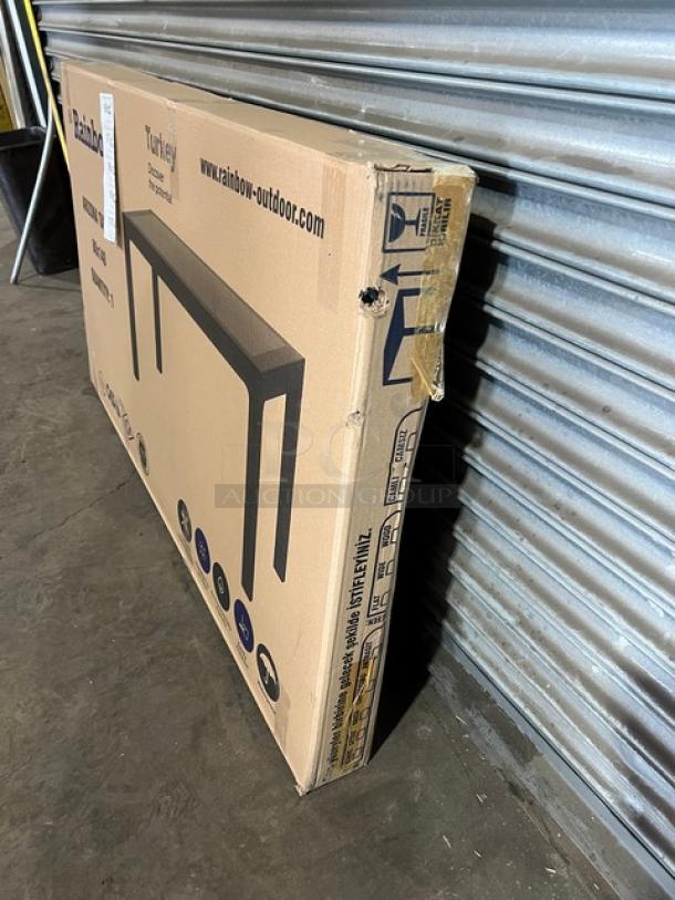 Brand new Rainbow Arizona outdoor table, 140"x80", brown faux wood, polypropylene, rattan finish, in original packaging.