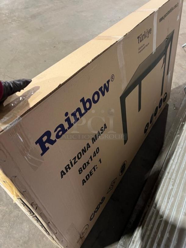 Brand new Rainbow Arizona 140"x80" outdoor dining table in box. Brown polypropylene faux wood, rattan finish, on legs.