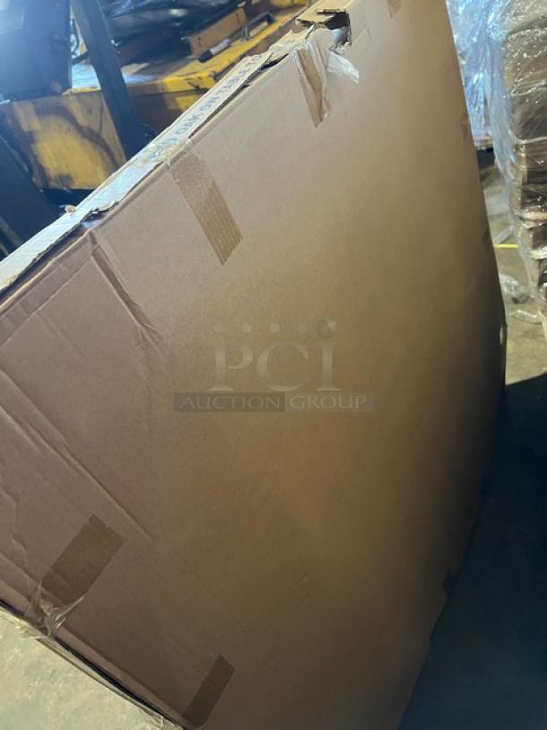 Shipping box containing a brand new 42" round red oak dining table with textured finish and regular height base.