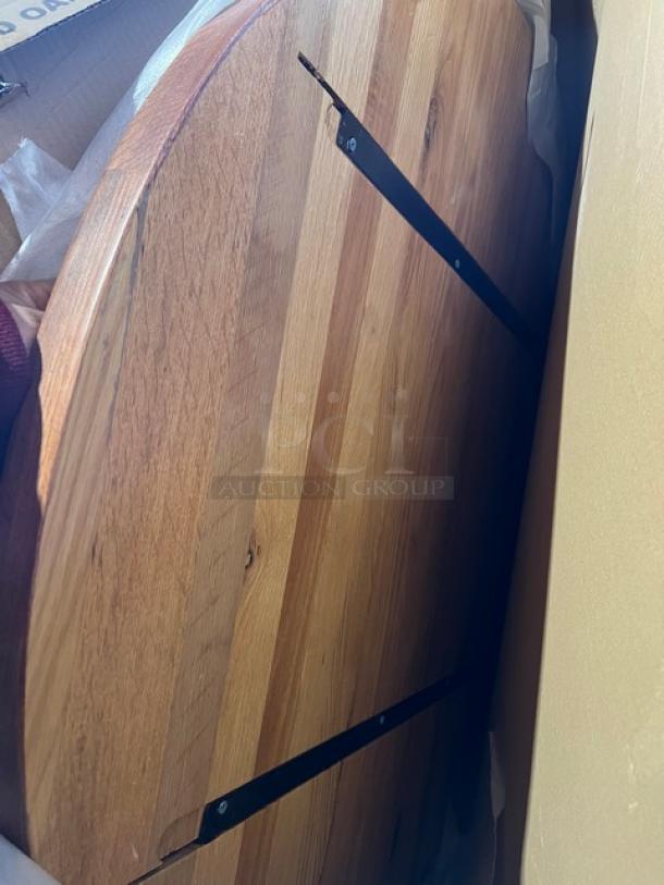 Brand new commercial red oak 42" round textured dining table with regular height base. Features durable, rich wood finish.