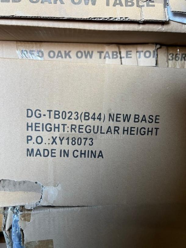 Brand new 36" round red oak dining table, textured surface, regular height base. Label stamps: "DG-TB023 B44," Made in China.