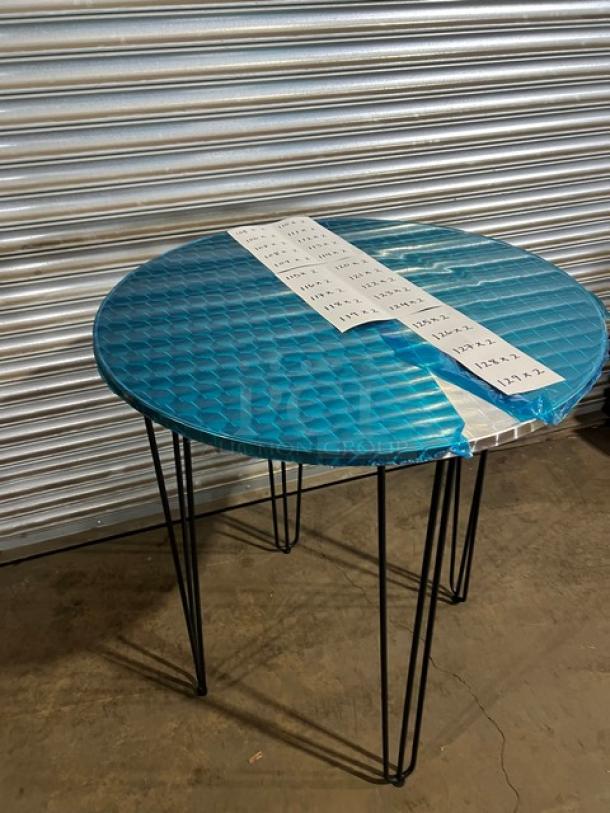 Brand new aluminum round dining table with matte steel hairpin legs, model TAD36, in protective wrapping.