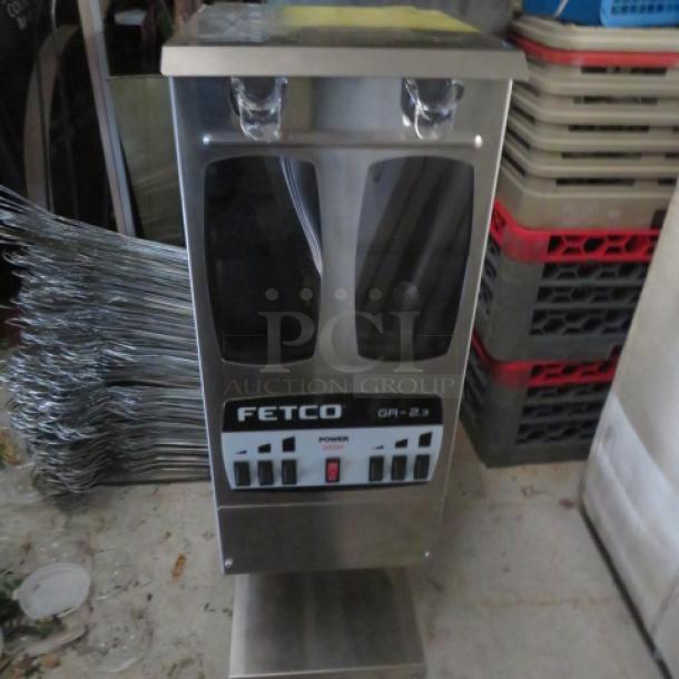 Fetco GR2.3 dual hopper coffee grinder, new, portion-controlled, 120V, includes manual, measures 9x16x28.5 inches.
