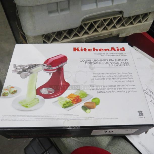 Kitchenaid Vegetable Sheet Cutter Mixer Attachment, new in box, features sheet-cutting for vegetables. Model shown on packaging.
