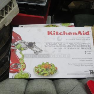 Kitchenaid Spiralizer Plus Mixer Attachment box, new condition, includes 7 blades, features peeling, coring, and slicing functions.