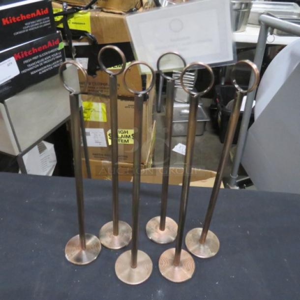 Set of six metal table markers with circular holders, in good condition, ideal for restaurants or events.