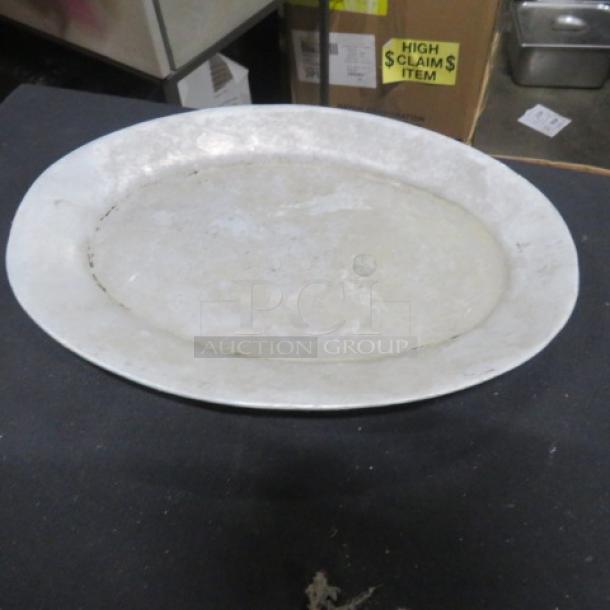 11.5x8 inch aluminum platter, silver-toned, lightly worn, oval shape. Suitable for serving or display.