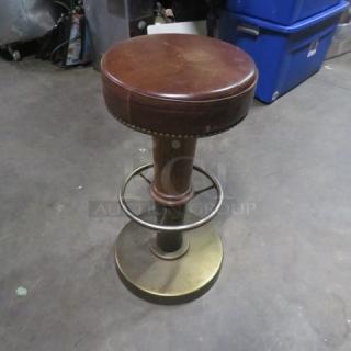 Metal/wooden barstool with brown leather cushioned seat, nailhead trim, and footrest. Sturdy condition, elegant design.