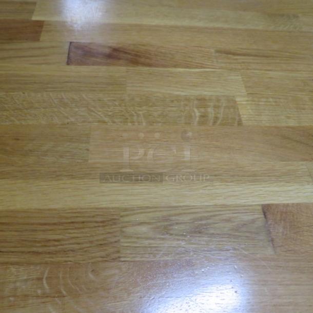 Solid wooden butcher block table with pedestal base, dimensions 48x30x30 inches. Features a polished wood surface.