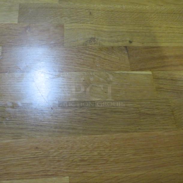 Solid wooden butcher block table with a pedestal base, measuring 24x30x30 inches. Appears in good condition.