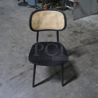 Black wooden chair with cane backrest, sturdy build, minimal wear. Simple modern design, 2XBID model.