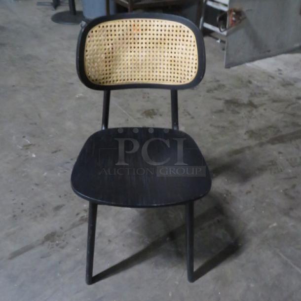 Black wooden chair with woven backrest, 2XBID model. Excellent condition, sturdy frame, ideal for stylish seating.