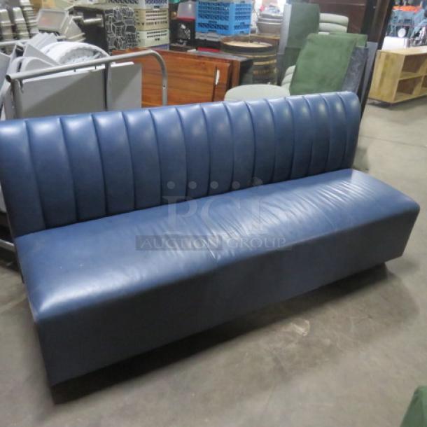 Blue cushioned single-sided booth, 75x26x34 inches. Features ribbed backrest, in good condition, suitable for waiting area.