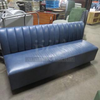 Blue cushioned booth bench, 75x26x34 inches, single-sided. Ribbed back, good condition, suitable for waiting areas.