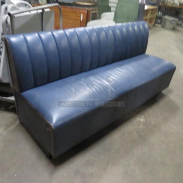 Single-sided blue cushioned booth, 75x26x34 inches, in good condition. Vertical stitching on backrest, sturdy design.