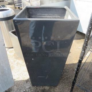 Tall black planter, 18.5x18.5x36 inches, glossy finish, minor surface scuffs, suitable for outdoor use.