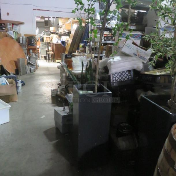 Tall rectangular planter with tree, 13.5x13.5x36 inches, in warehouse. Planter is dark-colored, in good condition.