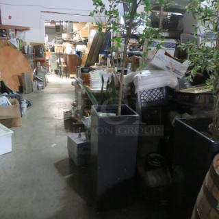 Tall rectangular planter with tree, 13.5x13.5x36 inches, in warehouse. Planter is dark-colored, in good condition.