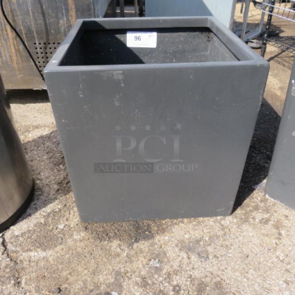 Square planter, 18x18x18.5 inches, grey finish, durable material, good condition, visible scuff marks.