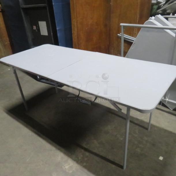 Cosco folding table, 72x29x30 inches, gray, metal legs, carrying handle, good condition, ideal for events or extra seating.