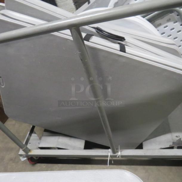 Metal table moving cart, sturdy frame, no tables included, visible wheels for easy transport, used condition.