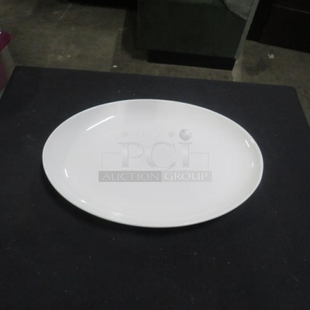 Fortessa platter, 13.5x9.5 inches, oval shape, pristine white, excellent condition, ideal for serving.