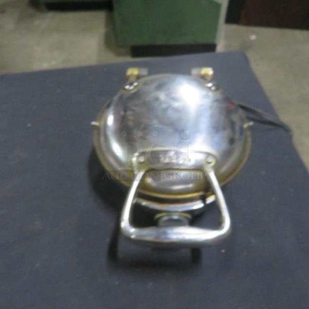 All Clad Stainless Steel Waffler Model 6071, 800 Watt, 120 Volt, circular design, sturdy handle, reflective finish.