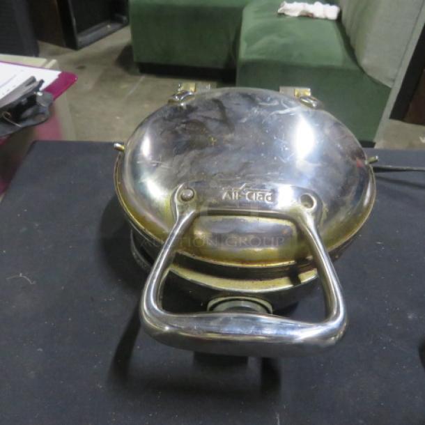 All Clad Model 6071 stainless steel waffler, 800 watt, 120 volt, slight surface wear, visible brand engraving.